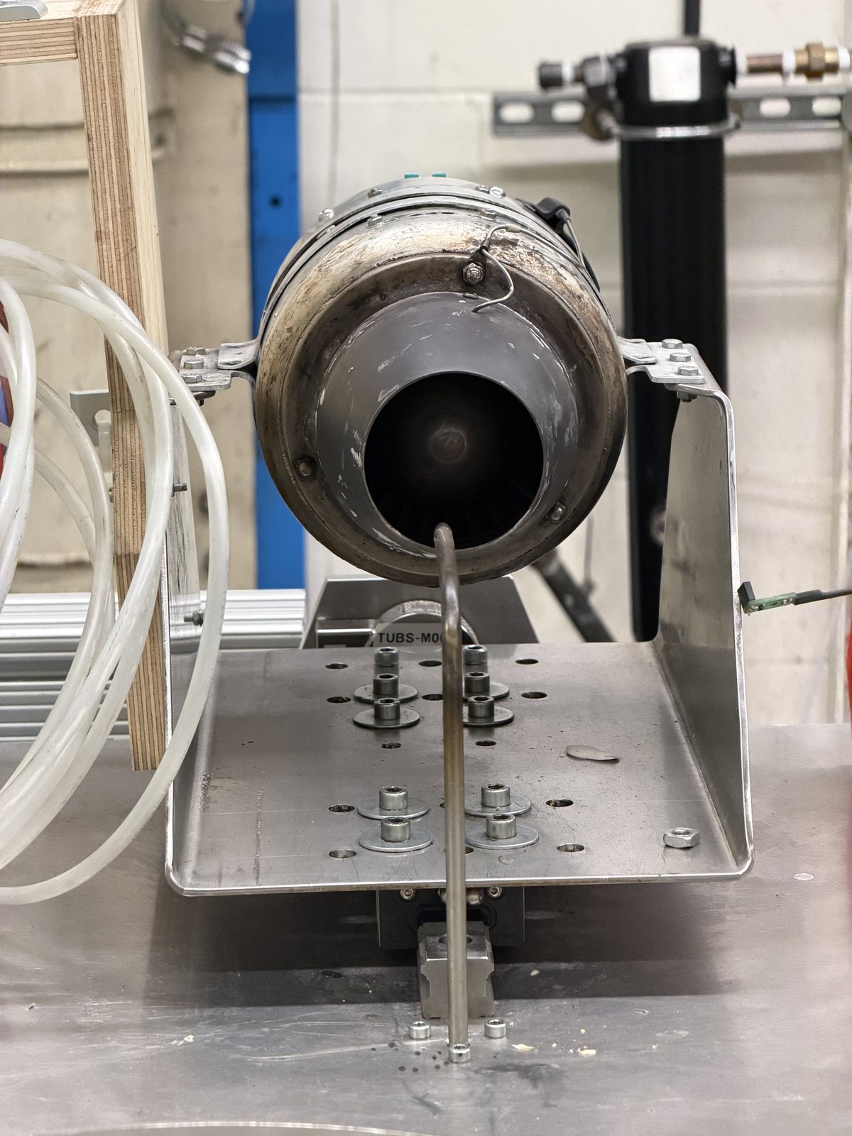 The nozzle-exit pitot probe, with its embedded thermocouple, characterizes the Station 8 nozzle-exit state. The probe is not centered in the jet.