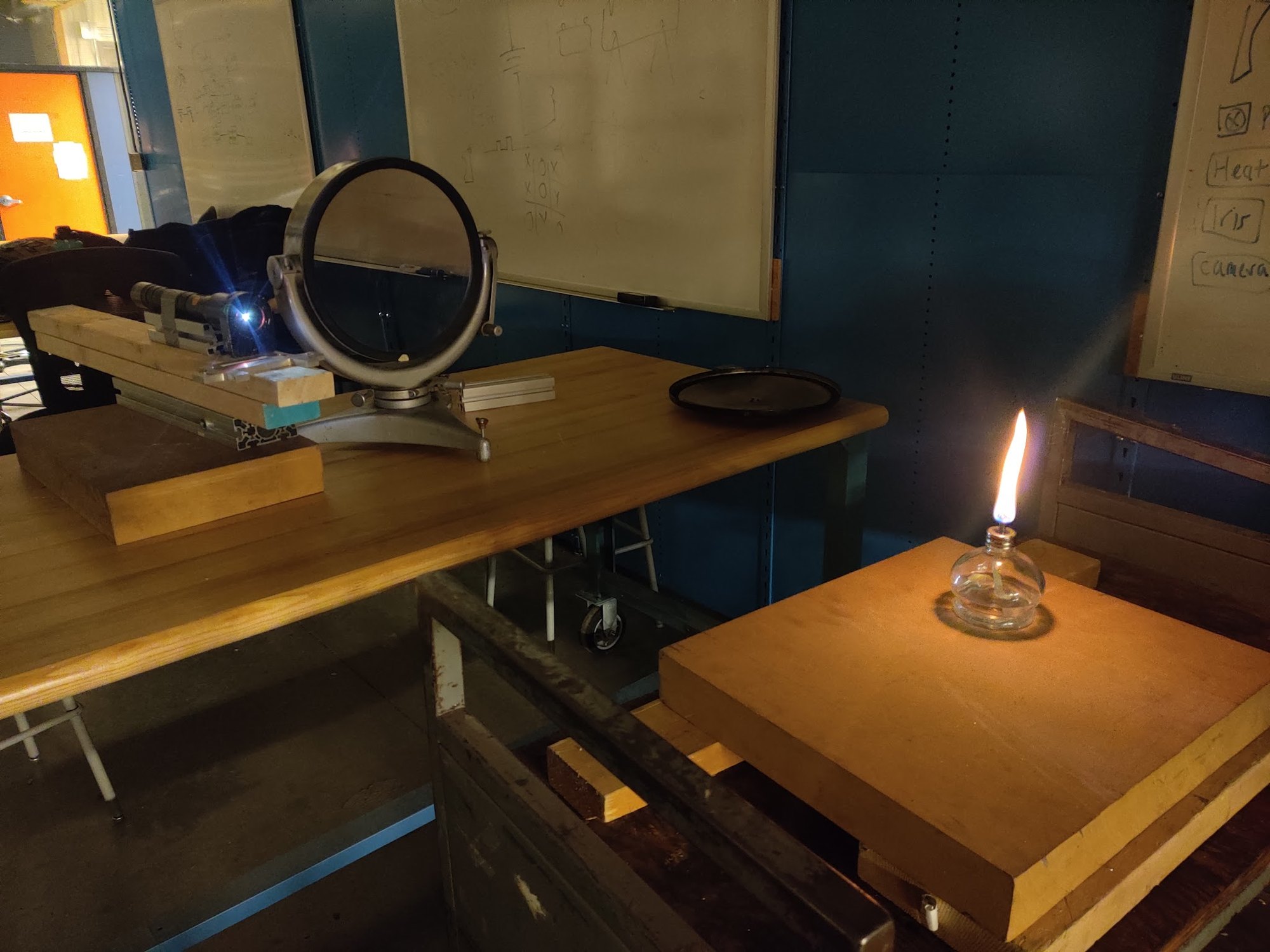 The bench in the dark lab: an 8 ft focal-length concave mirror, the light source and a candle in the test section